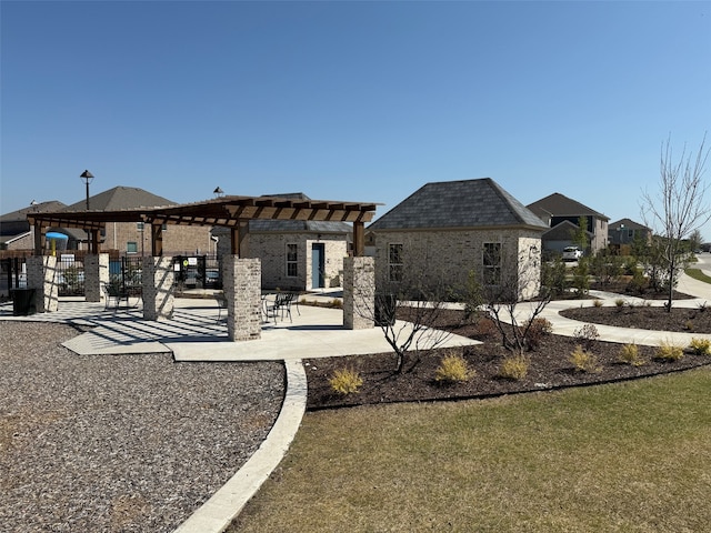 back of property featuring a pergola and a patio