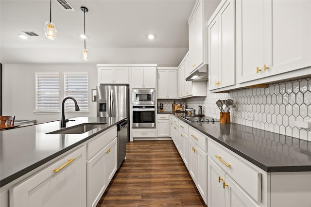 kitchen featuring dark countertops, visible vents, a sink, and appliances with stainless steel finishes