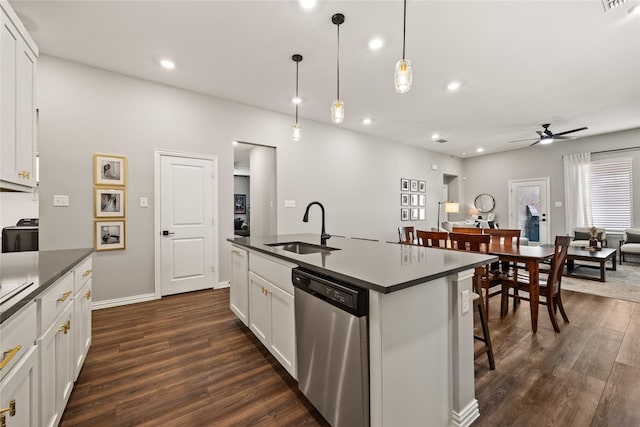 kitchen featuring dishwasher, a sink, ceiling fan, and dark wood-style flooring