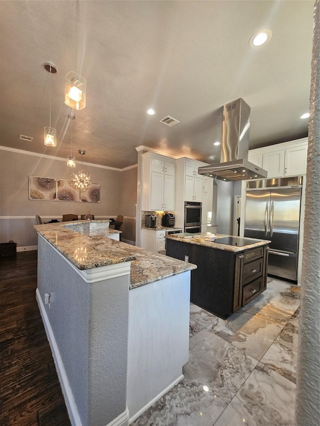 kitchen featuring white cabinets, a large island, visible vents, island range hood, and appliances with stainless steel finishes