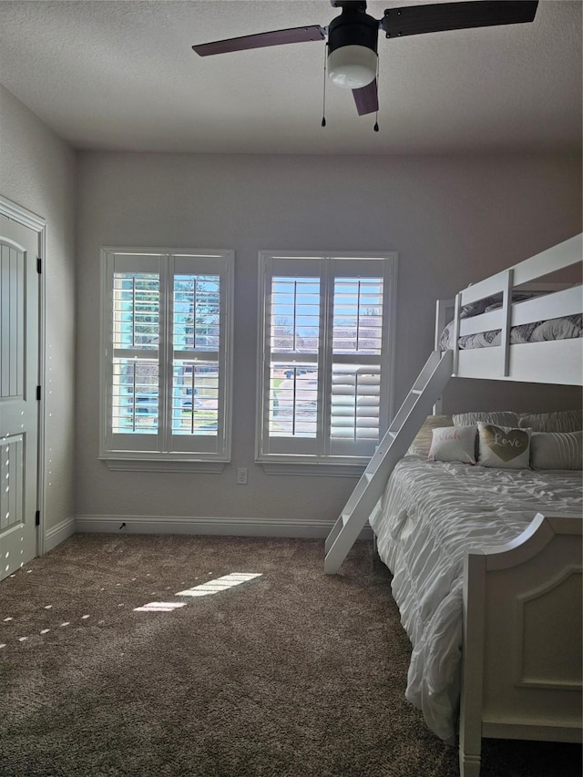 bedroom featuring carpet, baseboards, and multiple windows