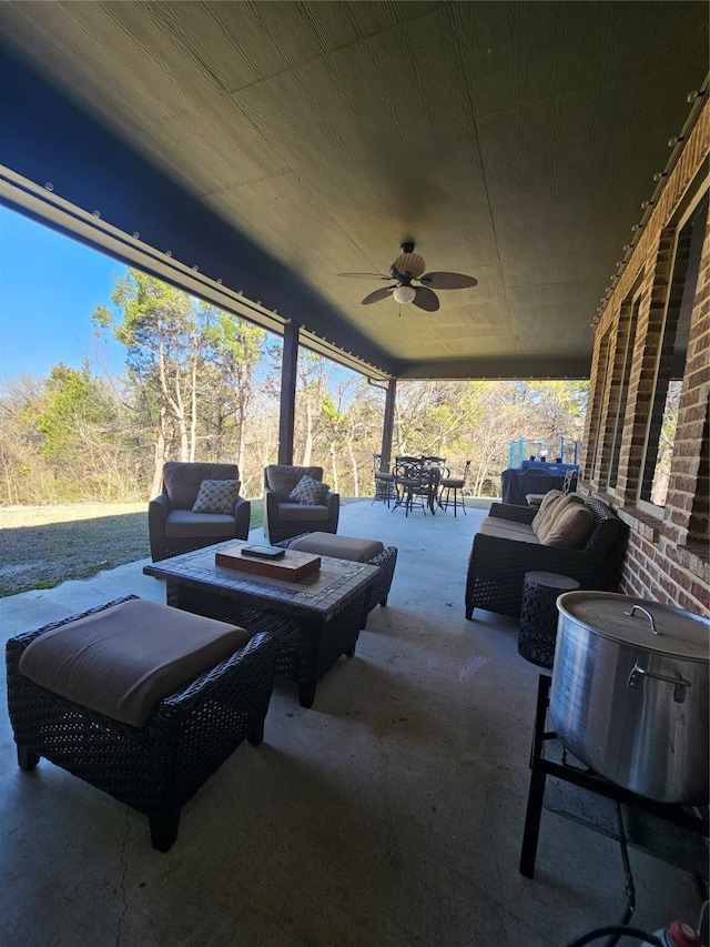 view of patio / terrace with outdoor dining space, ceiling fan, and an outdoor living space
