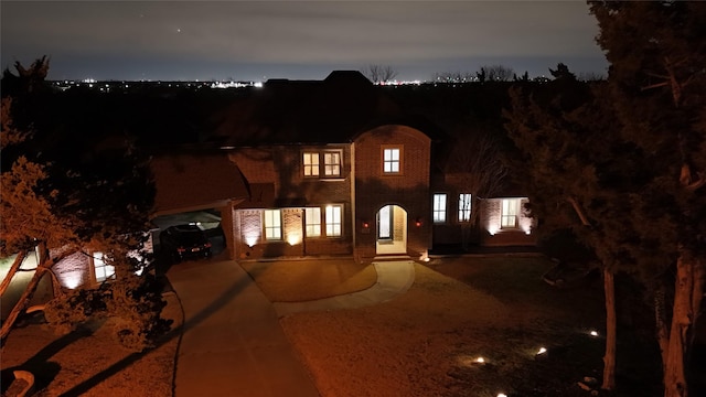 view of front of property featuring brick siding and driveway
