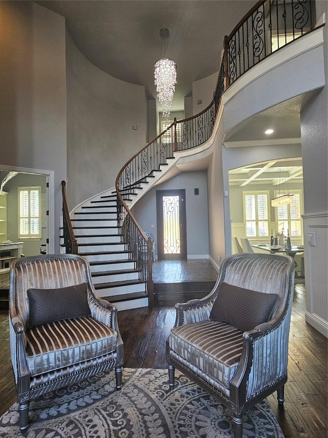 interior space featuring stairway, a high ceiling, a chandelier, and hardwood / wood-style floors