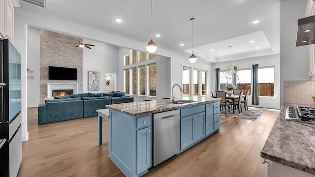 1651 Wynne Ave, Prosper, TX 75078 - kitchen featuring appliances with stainless steel finishes, blue cabinetry, a sink, light wood-type flooring, and recessed lighting