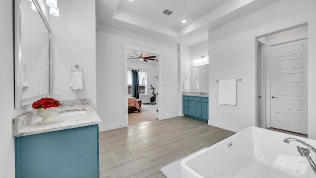 1651 Wynne Ave, Prosper, TX 75078 - full bath featuring a raised ceiling, a freestanding bath, ensuite bathroom, ceiling fan, and two vanities