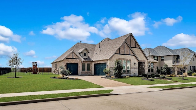 1651 Wynne Ave, Prosper, TX 75078 - tudor home with an attached garage, a playground, driveway, brick siding, and stone siding