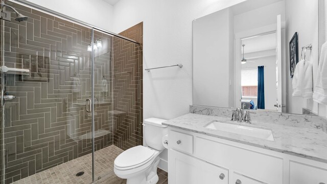 1651 Wynne Ave, Prosper, TX 75078 - full bathroom featuring a shower stall, toilet, vanity, and a ceiling fan