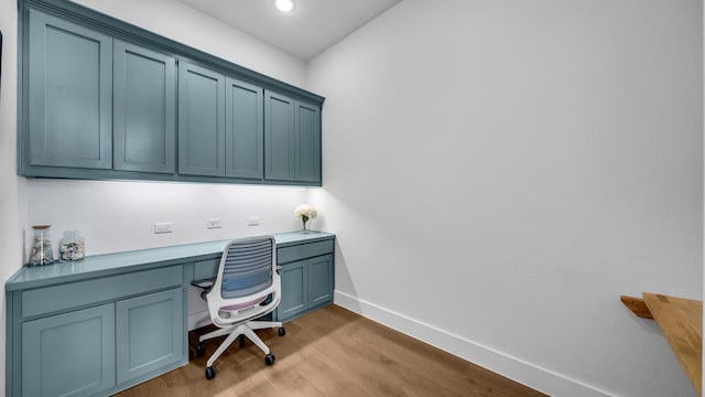 1651 Wynne Ave, Prosper, TX 75078 - office area featuring built in desk, baseboards, wood finished floors, and recessed lighting