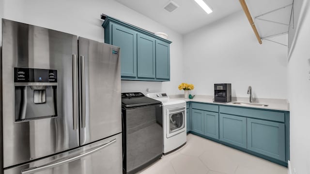 1651 Wynne Ave, Prosper, TX 75078 - washroom featuring washer and dryer, light tile patterned flooring, and cabinet space