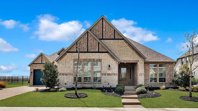 1651 Wynne Ave, Prosper, TX 75078 - view of front facade with stone siding, a shingled roof, brick siding, and driveway