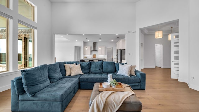 1651 Wynne Ave, Prosper, TX 75078 - living room with a high ceiling, baseboards, and light wood finished floors