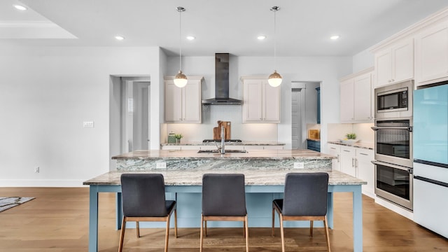 1651 Wynne Ave, Prosper, TX 75078 - kitchen featuring wall chimney exhaust hood, appliances with stainless steel finishes, a kitchen bar, backsplash, and recessed lighting