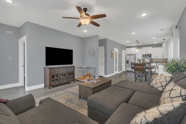 631 E Texas St, Denison, TX 75021 - living area featuring finished concrete flooring, ceiling fan, recessed lighting, and baseboards