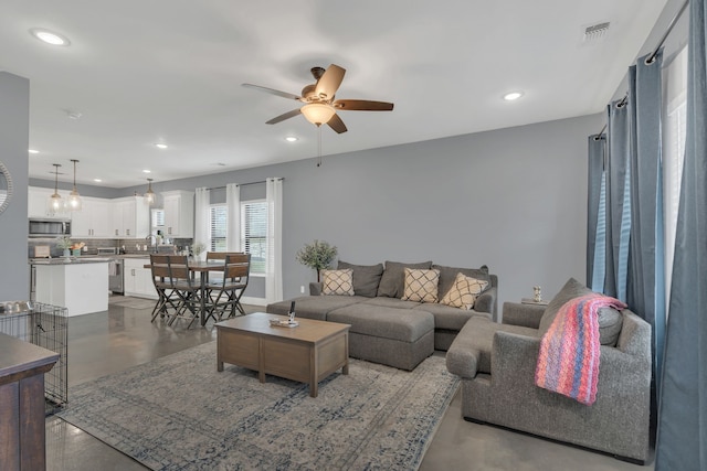 631 E Texas St, Denison, TX 75021 - living room featuring visible vents, recessed lighting, a ceiling fan, and finished concrete floors
