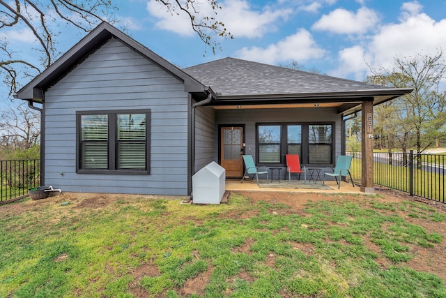 631 E Texas St, Denison, TX 75021 - back of house with fence private yard, a yard, and roof with shingles