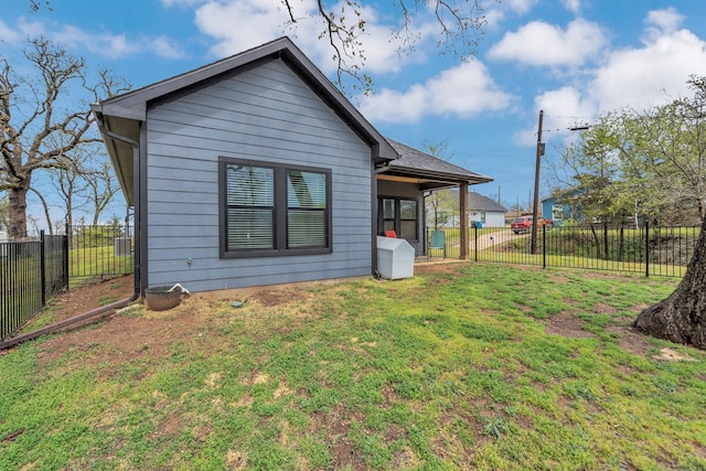 631 E Texas St, Denison, TX 75021 - back of property with a fenced backyard and a lawn