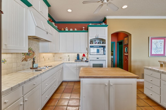 4204 Bluff View Dr, Granbury, TX 76048 - kitchen with a center island, white appliances, white cabinetry, and ceiling fan