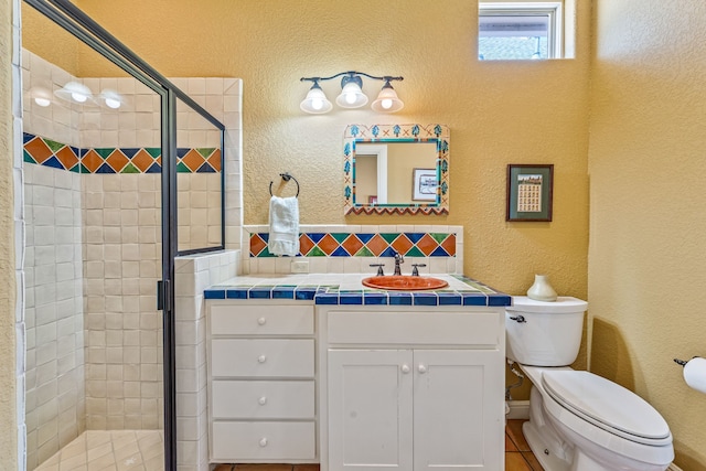 4204 Bluff View Dr, Granbury, TX 76048 - full bath featuring toilet, vanity, a shower stall, tasteful backsplash, and a textured wall