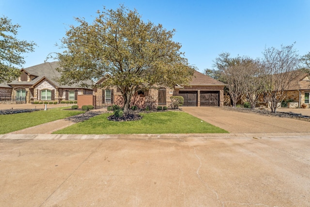 4204 Bluff View Dr, Granbury, TX 76048 - view of front of house with a front yard, stone siding, concrete driveway, and a garage