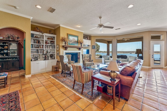 4204 Bluff View Dr, Granbury, TX 76048 - living area featuring light tile patterned flooring, a fireplace, visible vents, and ceiling fan