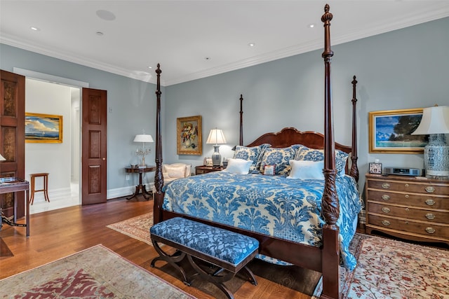 bedroom featuring baseboards, ornamental molding, wood finished floors, and recessed lighting