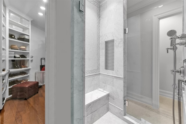 bathroom featuring crown molding, wood finished floors, a shower, and recessed lighting