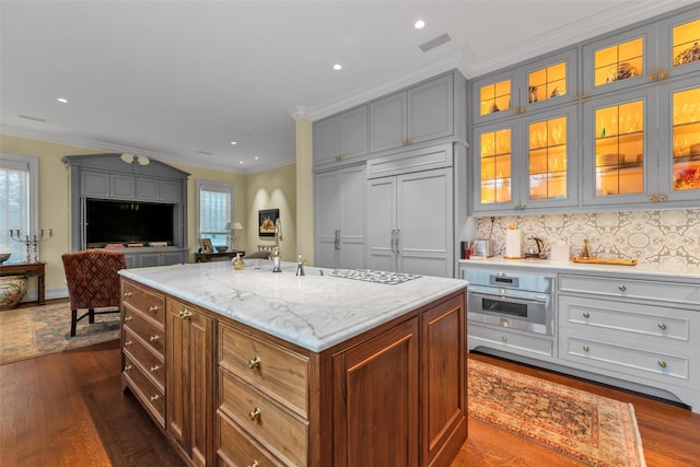 kitchen featuring oven, ornamental molding, dark wood-style floors, visible vents, and paneled refrigerator