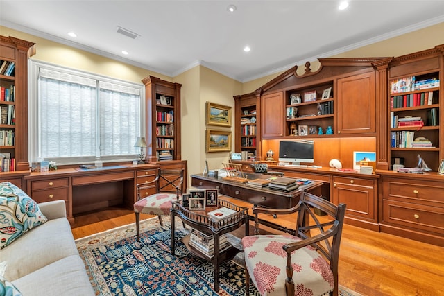 home office featuring crown molding, light wood-style flooring, visible vents, built in desk, and recessed lighting