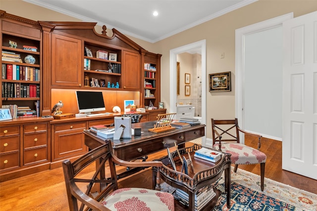 home office featuring ornamental molding, baseboards, and light wood-type flooring