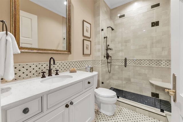 bathroom featuring toilet, vanity, and a shower stall