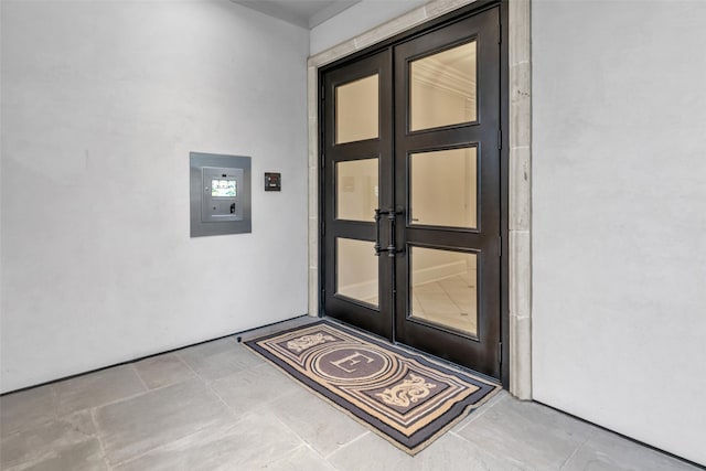 property entrance featuring french doors and stucco siding