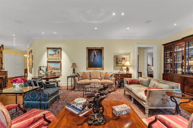 living area featuring baseboards, recessed lighting, and crown molding