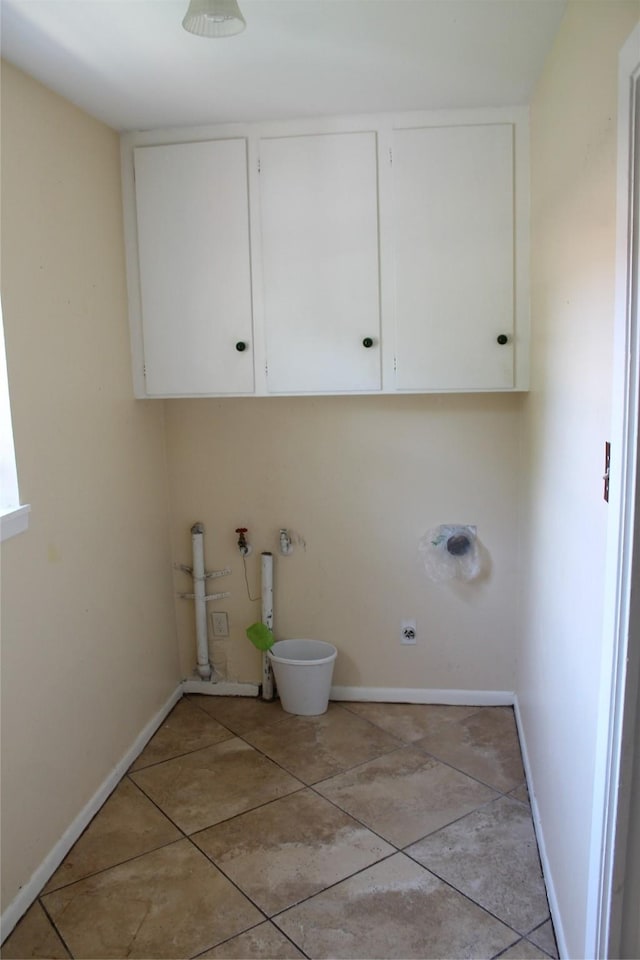 4605 Avoca St, Fort Worth, TX 76132 - laundry room with cabinet space, baseboards, and light tile patterned floors
