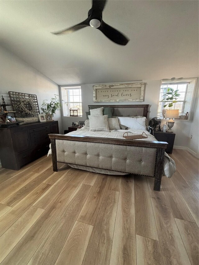 bedroom with baseboards, ceiling fan, and light wood-type flooring