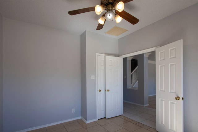 unfurnished bedroom with light tile patterned floors, a closet, visible vents, and baseboards