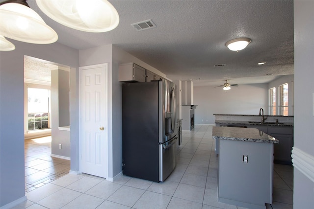 kitchen featuring visible vents, ceiling fan, plenty of natural light, and stainless steel fridge with ice dispenser