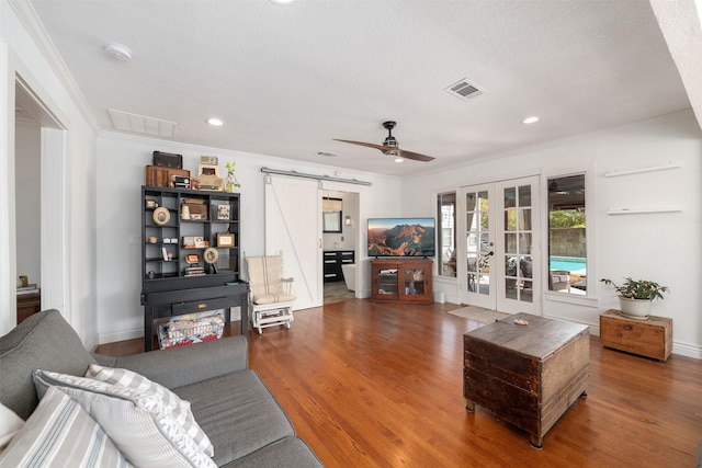 320 Eastwood Ave, Fort Worth, TX 76107 - living area featuring french doors, crown molding, a barn door, wood finished floors, and ceiling fan