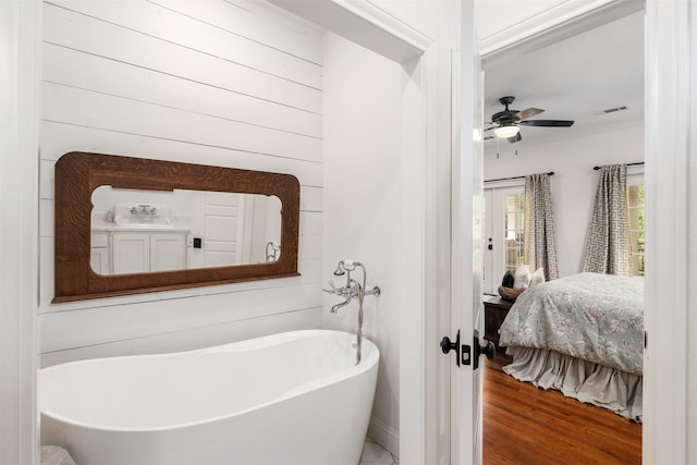 320 Eastwood Ave, Fort Worth, TX 76107 - ensuite bathroom featuring a freestanding tub, a ceiling fan, and wood finished floors