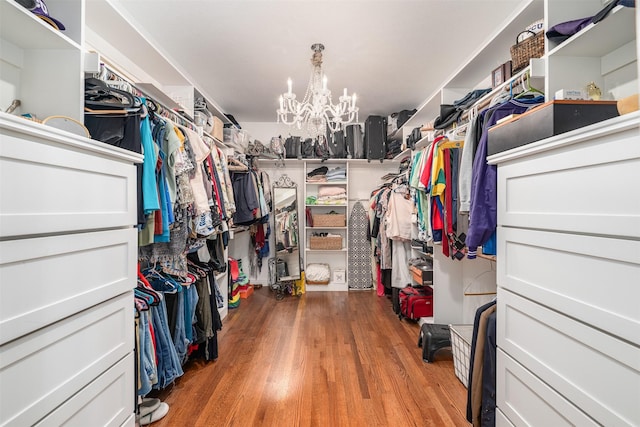 320 Eastwood Ave, Fort Worth, TX 76107 - walk in closet featuring wood finished floors and a chandelier