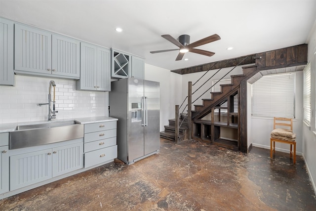 320 Eastwood Ave, Fort Worth, TX 76107 - kitchen with stainless steel fridge, a sink, a ceiling fan, gray cabinets, and tasteful backsplash