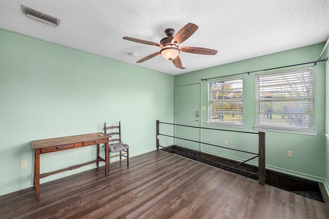 320 Eastwood Ave, Fort Worth, TX 76107 - empty room featuring a textured ceiling, wood finished floors, a ceiling fan, and baseboards