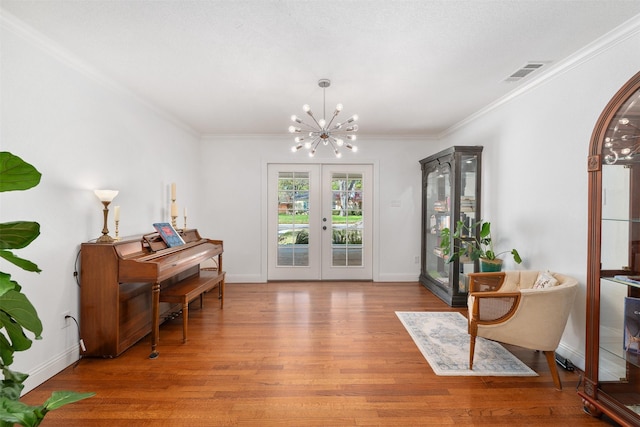 320 Eastwood Ave, Fort Worth, TX 76107 - sitting room featuring a chandelier, light wood-style flooring, french doors, crown molding, and baseboards