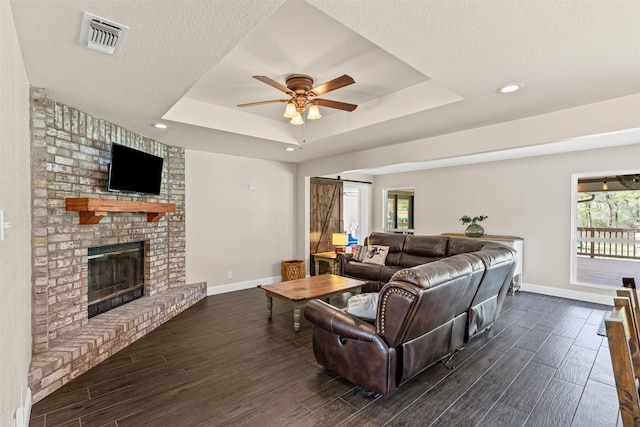 161 Mariah Dr, Weatherford, TX 76087 - living area featuring a tray ceiling, baseboards, dark wood-style floors, a ceiling fan, and recessed lighting