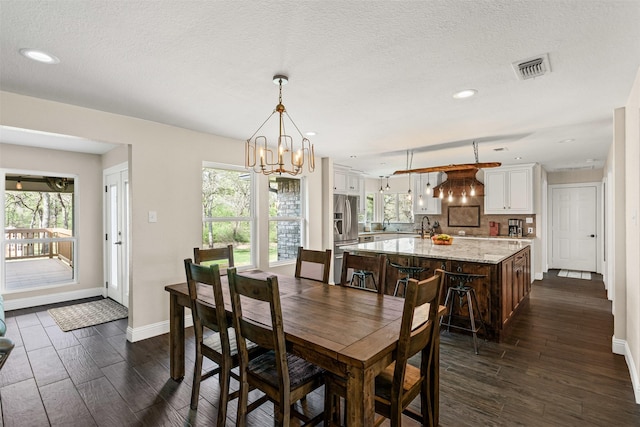 161 Mariah Dr, Weatherford, TX 76087 - dining room featuring dark wood-style flooring, a chandelier, baseboards, recessed lighting, and a textured ceiling