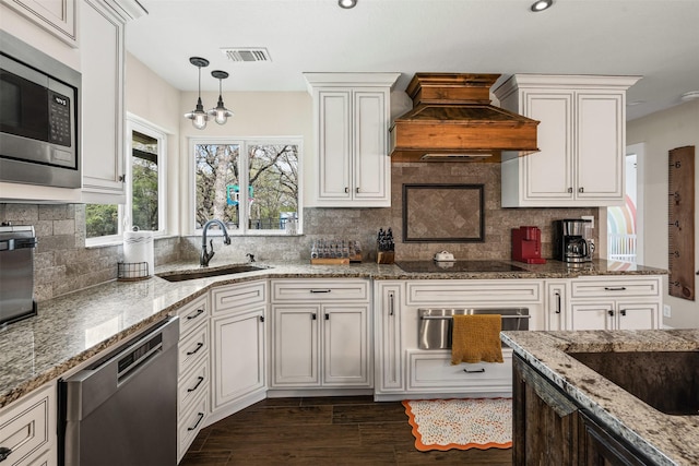 161 Mariah Dr, Weatherford, TX 76087 - kitchen with stainless steel appliances, a sink, custom exhaust hood, a warming drawer, and a chandelier