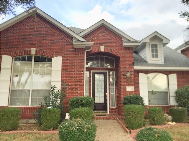 view of exterior entry with brick siding