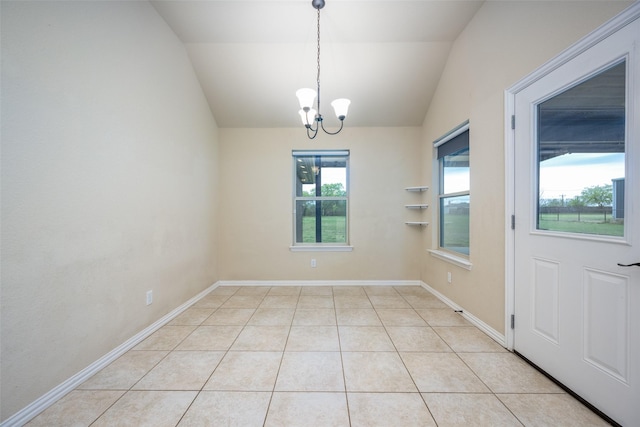 spare room with light tile patterned flooring, baseboards, lofted ceiling, and an inviting chandelier