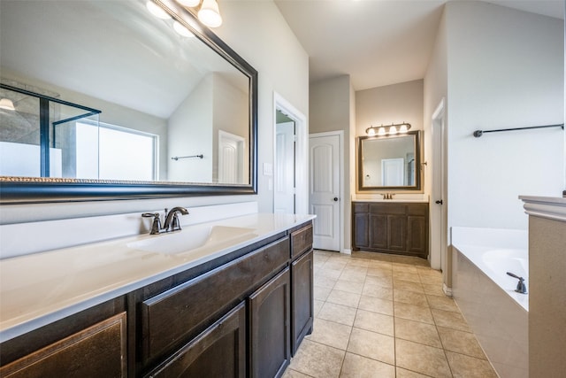 full bathroom featuring tile patterned floors, a garden tub, a sink, and two vanities