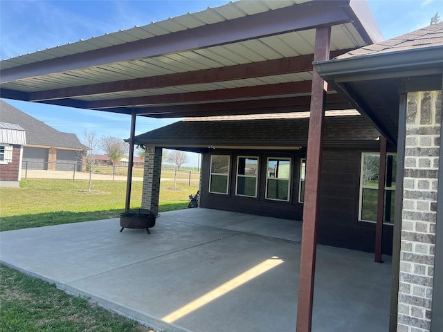 view of patio / terrace featuring an outdoor fire pit and fence